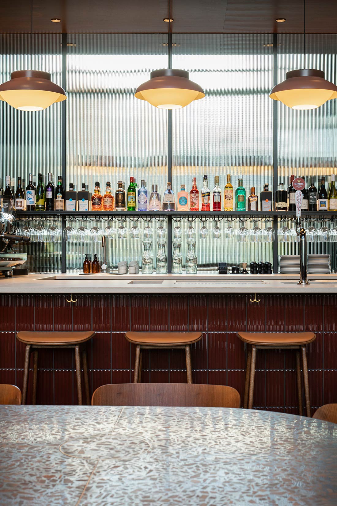 View over bar with bottles and glasses View over bar with bottles and glasses