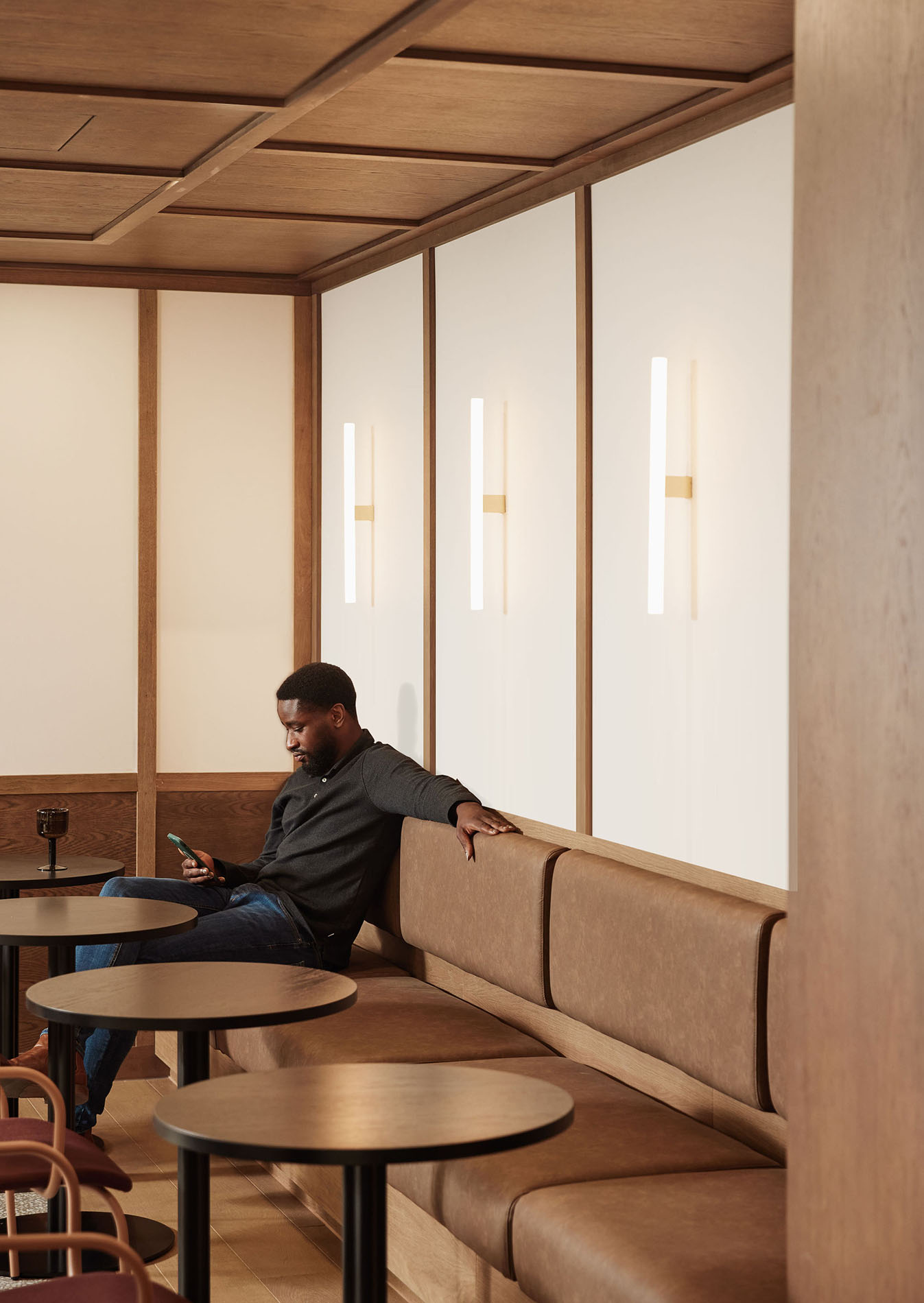 Man sitting with phone on sofa Man sitting with phone on sofa
