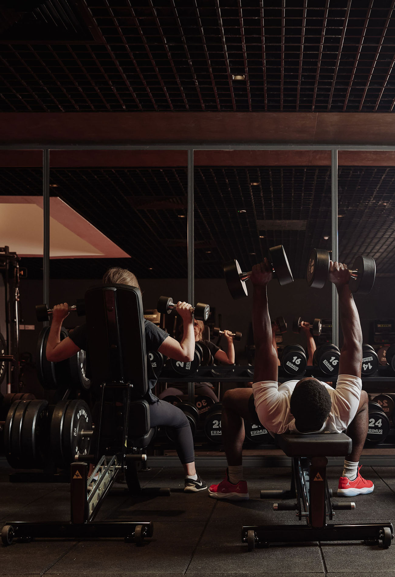 People using weights in gym People using weights in gym